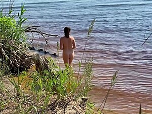 Spy sexy nudist girl on a wild beach